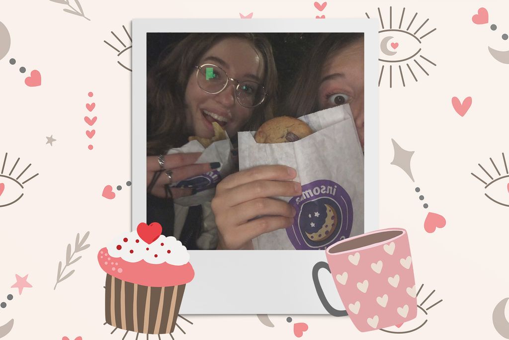 Image: Polaroid style selfie photo of 2 white women holding up Insomnia cookies and smiling . Polaroid is placed on a tan background with a pattern of eyes with moons as irises, stars, pink hearts, a cupcake, and a mug