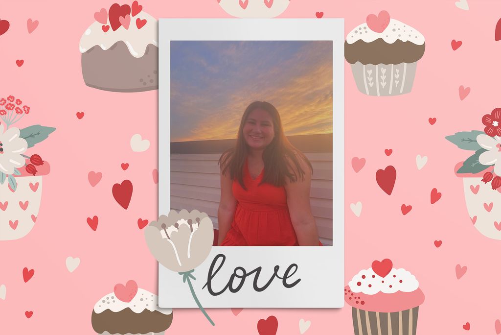 Image: Polaroid style photo of a seated woman posing and smiling for the camera in front of a scenic sunset. Polaroid is placed on a light pink background of red and pink hearts, cupcakes, and tan flowers.