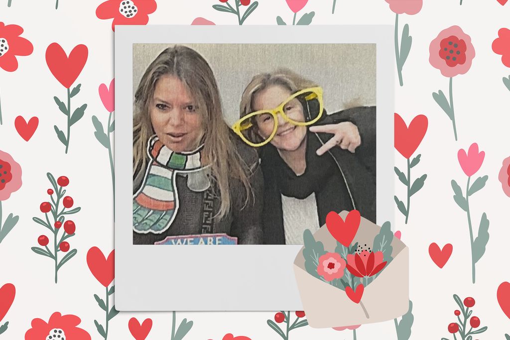 Image: Polaroid style photo of 2 white women, one wearing oversized yellow glasses and the other a prop scarf, as they make silly poses for the camera. Polaroid is placed on a tan background with a pattern of red, tan, and pink flowers, red hearts, and a large envelope overflowing with various flowers