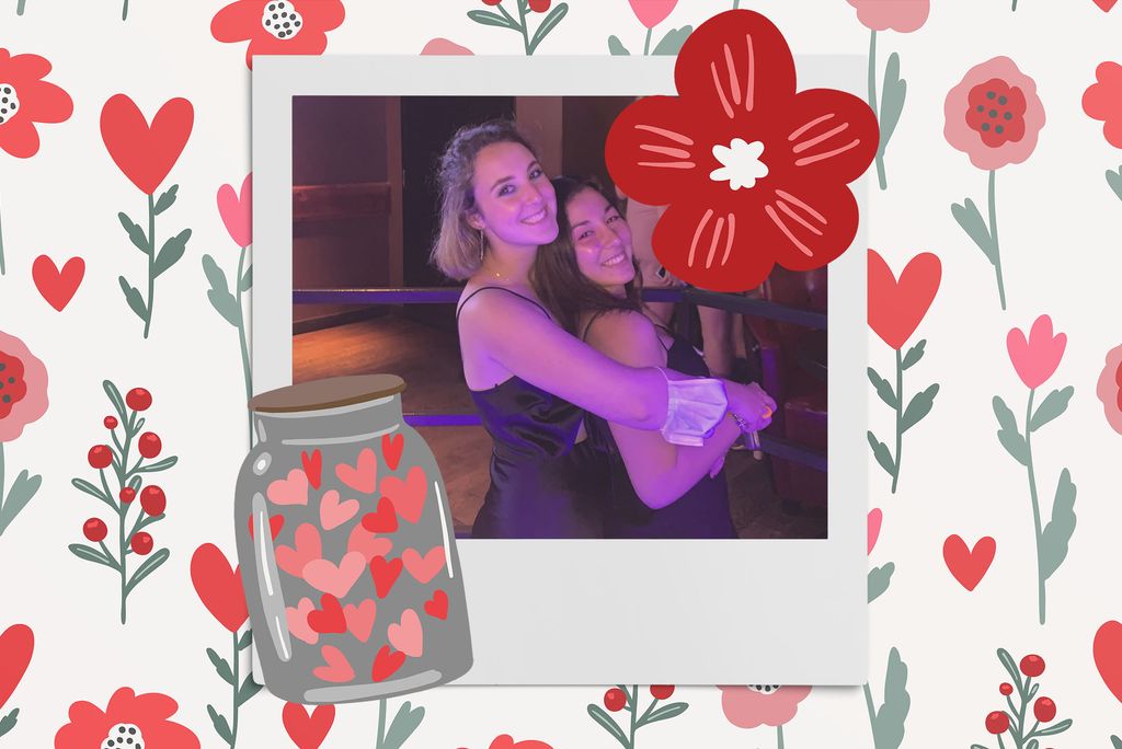 Image: Polaroid style photo of two women smiling and posing together in a room with purple mood lighting . Polaroid is placed on a tan background with a pattern of red and pinks flowers, red heart flowers, a red flower, and a jar of hearts