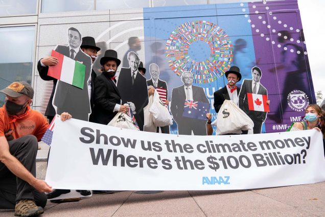 Photo of activists holding cardboard cutouts of President Joe Biden, Canadian Prime Minister Justin Trudeau, Australian Prime Minister Scott Morrison, Britain's Prime Minister Boris Johnson and Italian Prime Minister Mario Draghi protest outside of the International Monetary Fund headquarters during the World Bank/IMF Annual Meetings in Washington, Wednesday, Oct. 13, 2021.