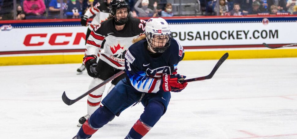 Photo of Jesse Compher (SHA’21) playing during the 2016 U-18 World Junior Championship. She is tailed by a Canadian defender.