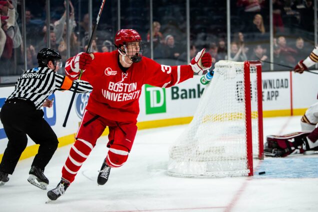 Photo of Wilmer Skoog (CAS‘23) scoring the game-winning goal in double overtime during the 2020 Beanpot semifinal. He shakes his fists in celebration; a ref and goal are seen behind him on the ice.