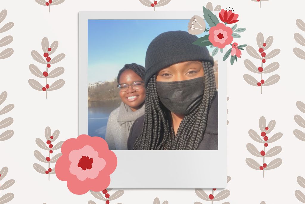 Image: Polaroid style  selfie photo of 2 black women in front of a lake. One smiles and the other wears a black face mask. Polaroid is placed on a light tan background with a pattern of muted dark tan sprigs of leaves. 2 red and pink flowers border the polaroid.