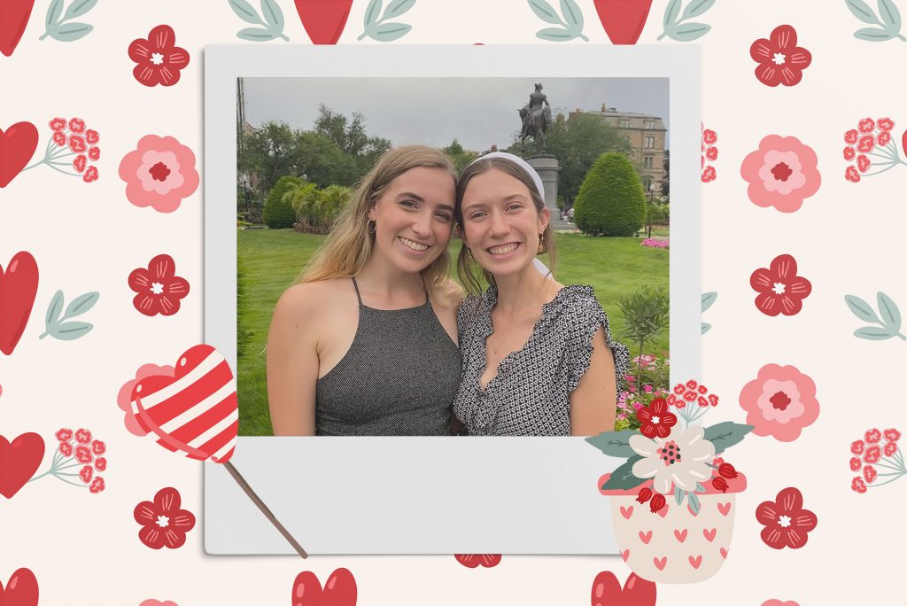 Image: Polaroid style photo of 2 white women looking forward and smiling to the camera. Polaroid is placed on a background of red hearts, pink and red flowers, and rainbows. a vase of tan and red flowers, and a red and white striped heart lollipop