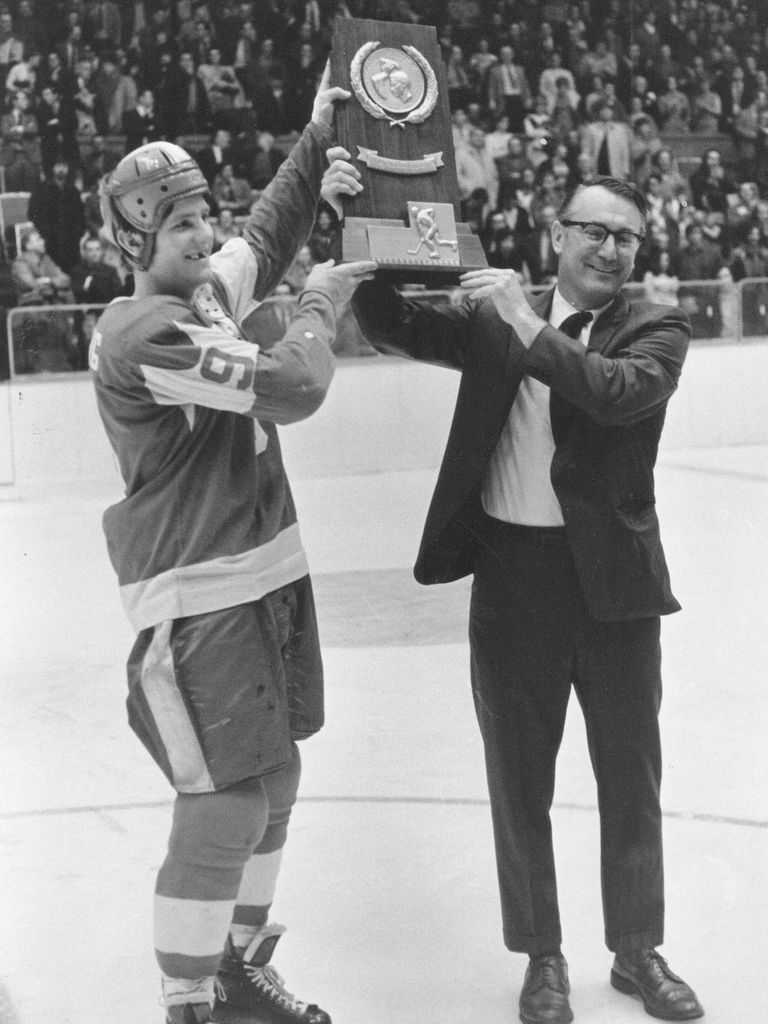 Head coach Jack Kelley (right) and captain Steven Stirling (Wheelock’71,’81) hoisting BU’s first national championship trophy in 1971.