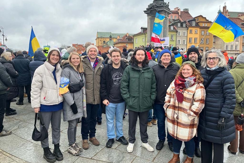 The Fulbright Ukraine crew at a Ukrainian Solidarity Demonstration on February 20 in Warsaw’s Old Town, just before Russia launched the full-scale invasion. Wyn Pennybacker (from left), Tamara Kozyckyj, Alex Hryhorczuk, Eric Matherly, Evan Lenzen, Michael Sampson, Nicole Jepeal (CAS’11), John Vsetecka, and Larysa Kurylas. Photo courtesy of Nicole Jepeal
