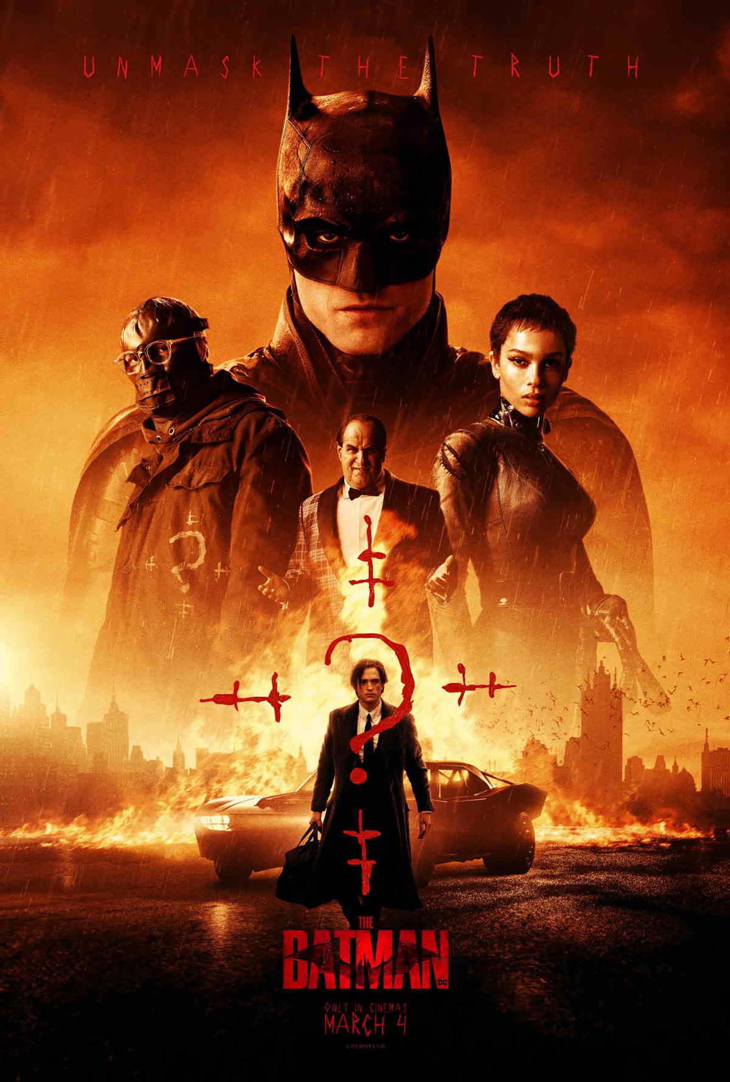 Movie poster for the Batman 2022 movie. The poster features the new cast, Robert Pattinson as Bruce Wayne (Batman), Zoë Kravitz as Selina Kyle (Catwoman), and Paul Dano as Edward Nashton (The Riddler). The poster has dramatic lighting with a yellow/orange tinge. At the top, "unmask the truth" is written in creepy red letters, and "The Batman, March 4" is seen at the bottom below a photo of Pattinson walking away from a car with a fire behind it in a suit and carrying a brief case.