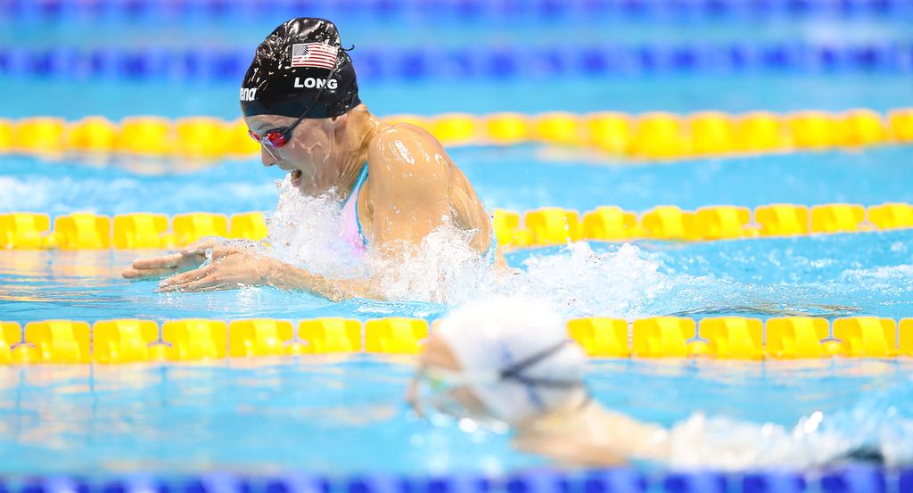 Photo of decorated Paralympian Jessica Long swimming in a pool with yellow lane dividers.