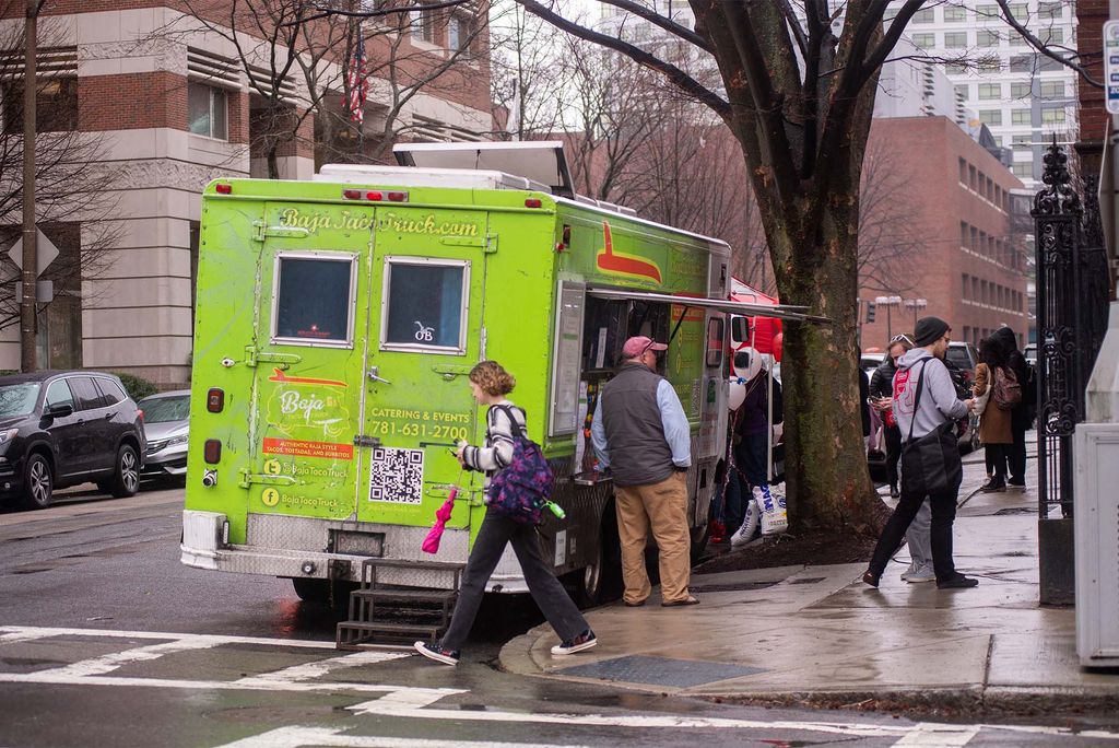 a food truck is parked on BU's campus in the rain