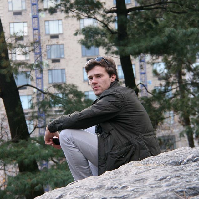 Dan Petrescu sits on a rock and looks over his shoulder