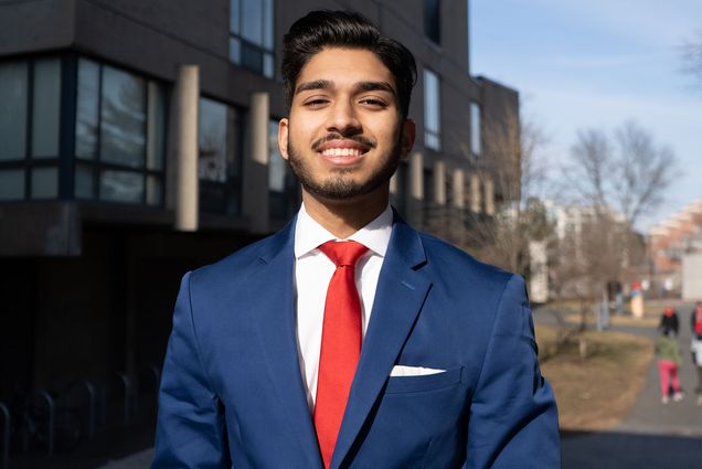 Dhruv Kapadia (CAS’24), incoming Student Government president, says his administration will be a “vehicle for change.” Photo by Arin Siriamonthep (Questrom’24). Here he is in a blue suit with a red tie on a sunny day