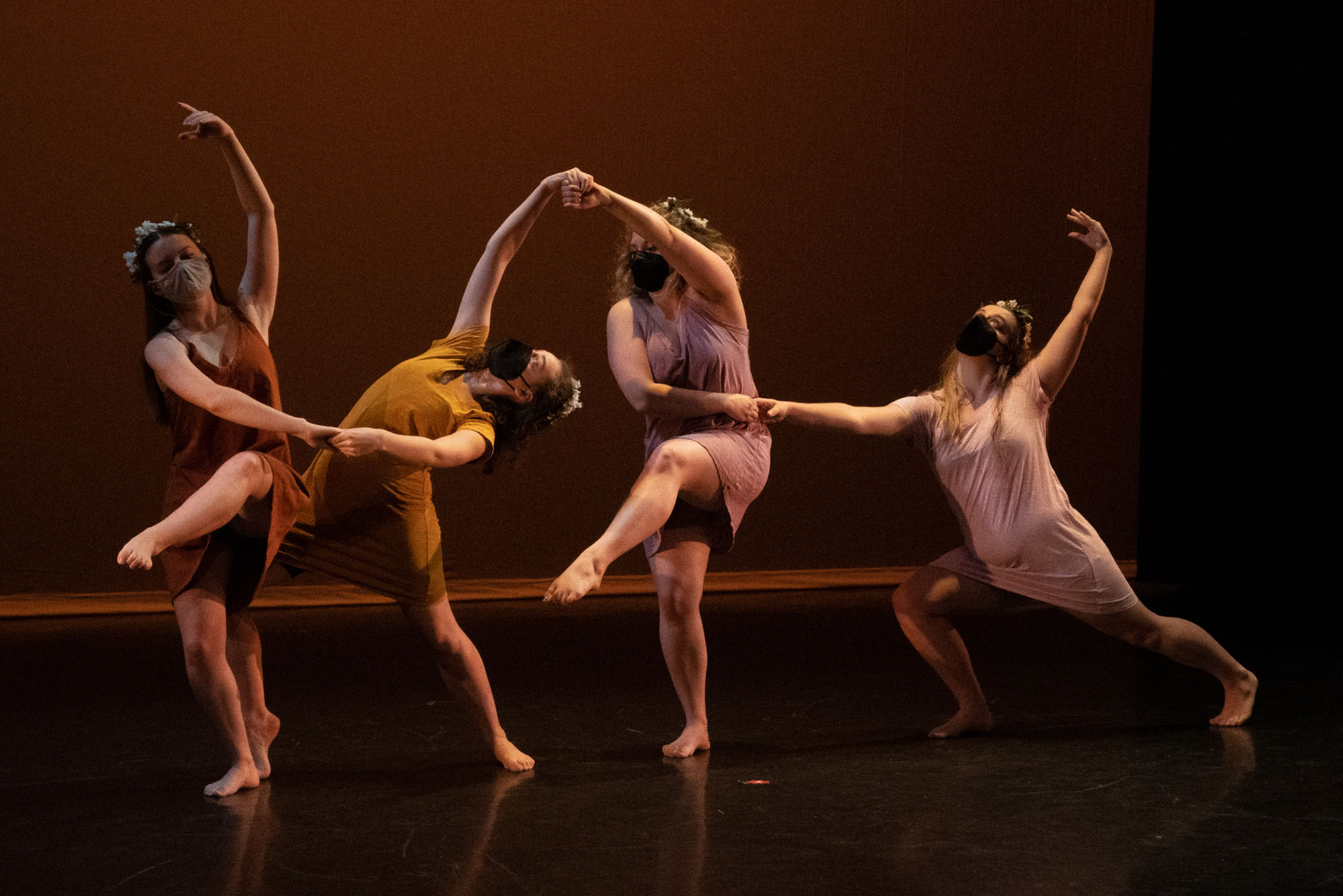 4 dancers contort their bodies on stage for Visions 2022