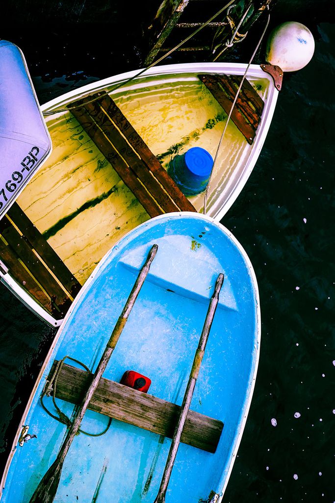 Overhead photo of two row boats on a murky body of water.