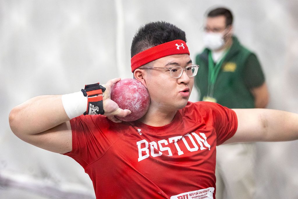 Fred Lu holding a shotput