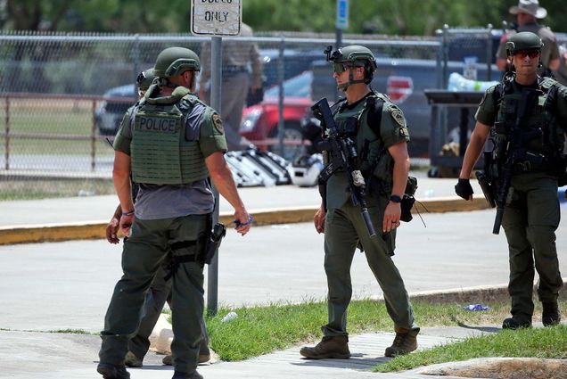 Law enforcement personnel stand outside Robb Elementary School following a shooting, Tuesday, May 24, 2022, in Uvalde, Texas. (AP Photo/Dario Lopez-Mills)