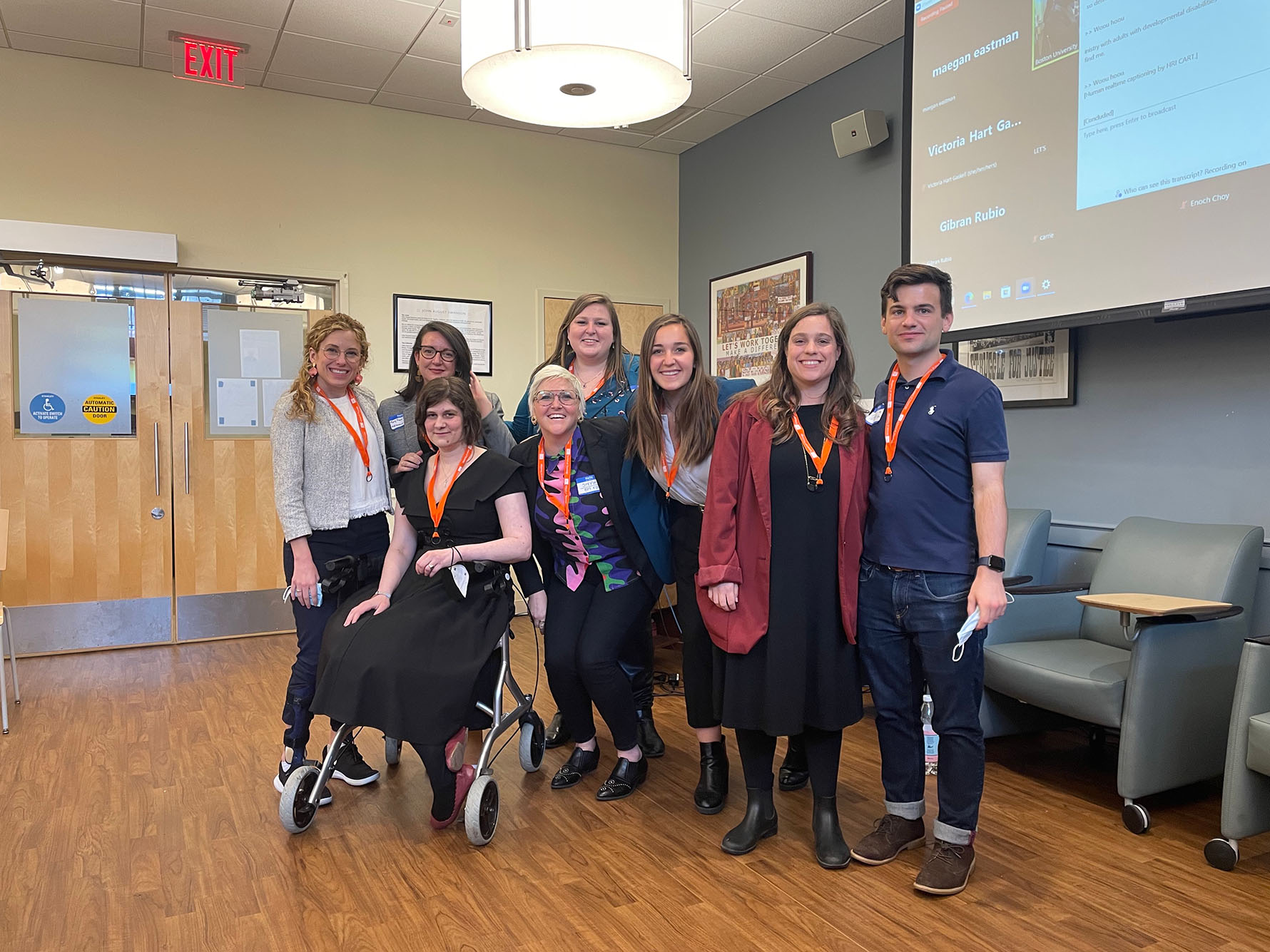 Photo of Eastman (second from right) with organizers of the School of Theology’s Accessing the Divine: Disability, Embodiment, and Claiming Joyous Futures conference. Various people stand (one person sits in a wheelchair) together as a group as they pose and smile for the camera.
