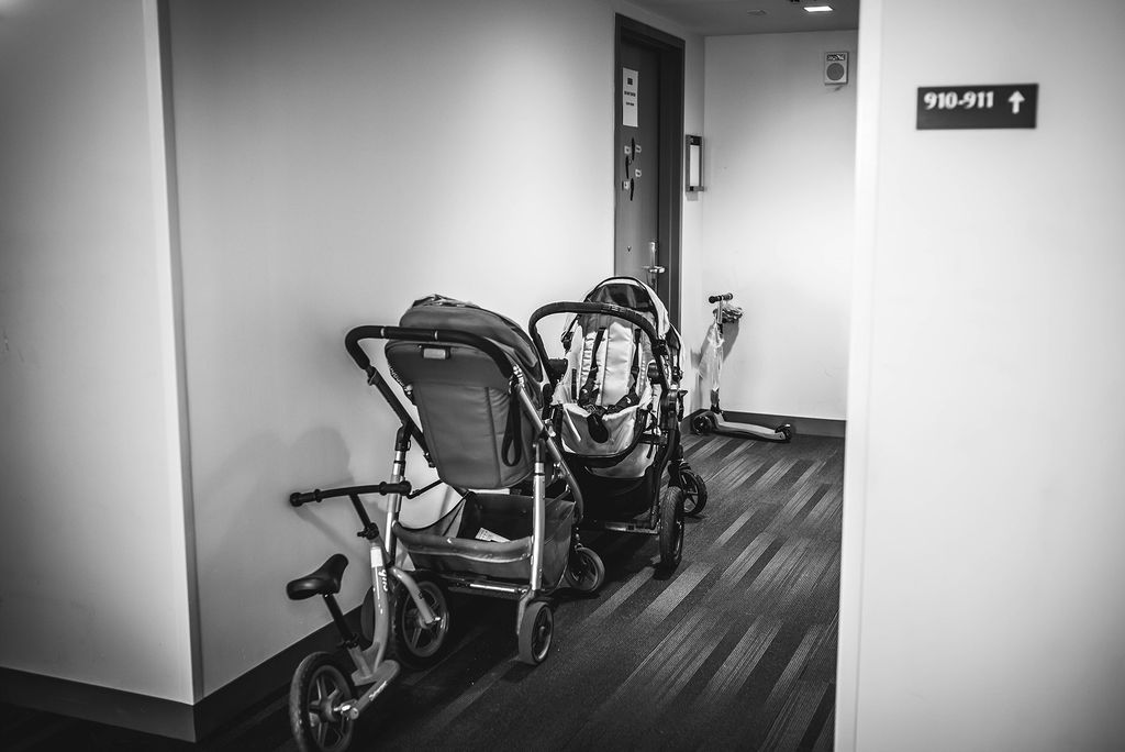 Strollers, scooters, and more outside of a faculty-in-residence apartment in Myles Standish Hall