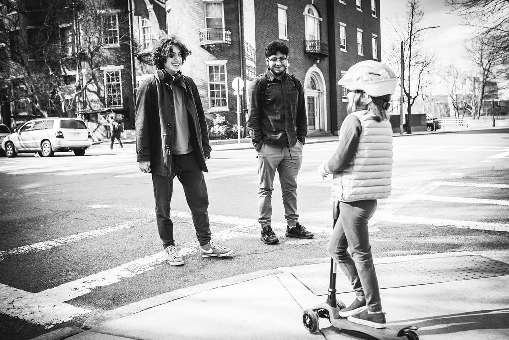 Out for a scooter ride with her family, Isla chats with Larry Algredo (CAS’25) (left) and Valentino Tartamella (ENG’25) about her favorite Paw Patrol characters. Her mother describes Isla as an extrovert who will happily chat with a bus driver or anyone she meets in the elevator at Myles Standish Hall.