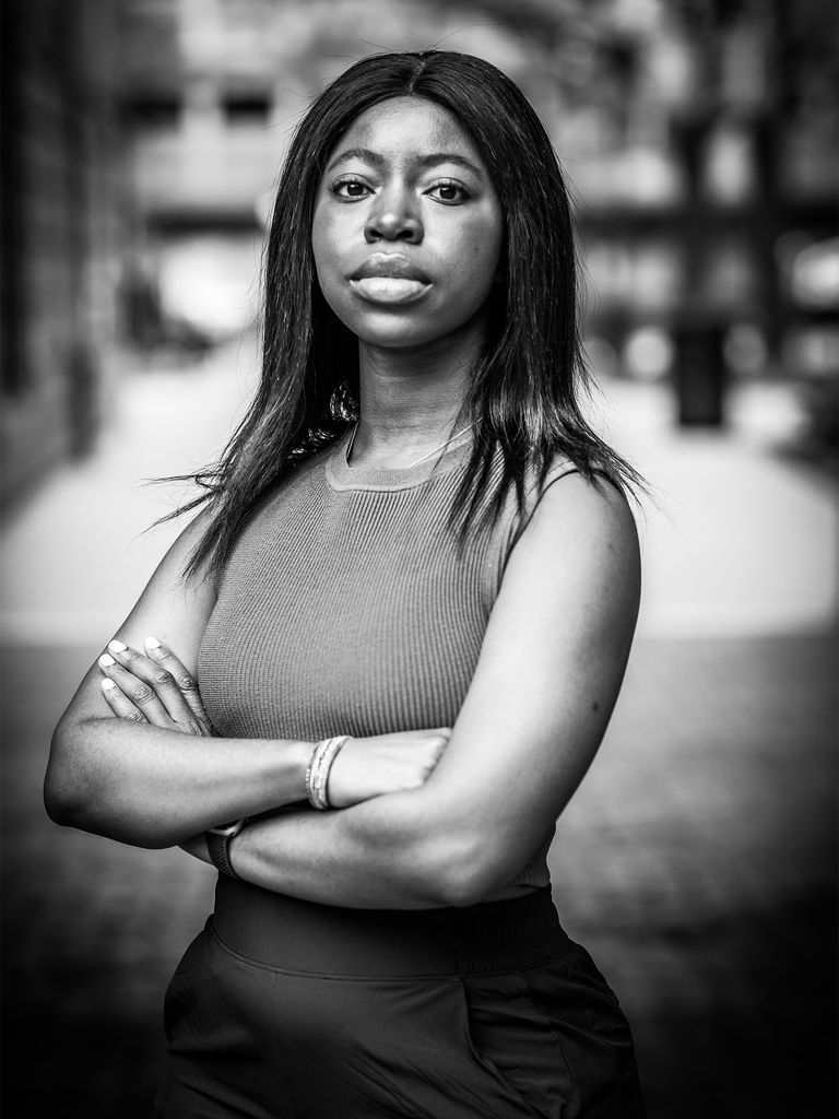 Tomeka Frieson (SPH’23) stands with arms crossed looking at the camera in this black and white photo