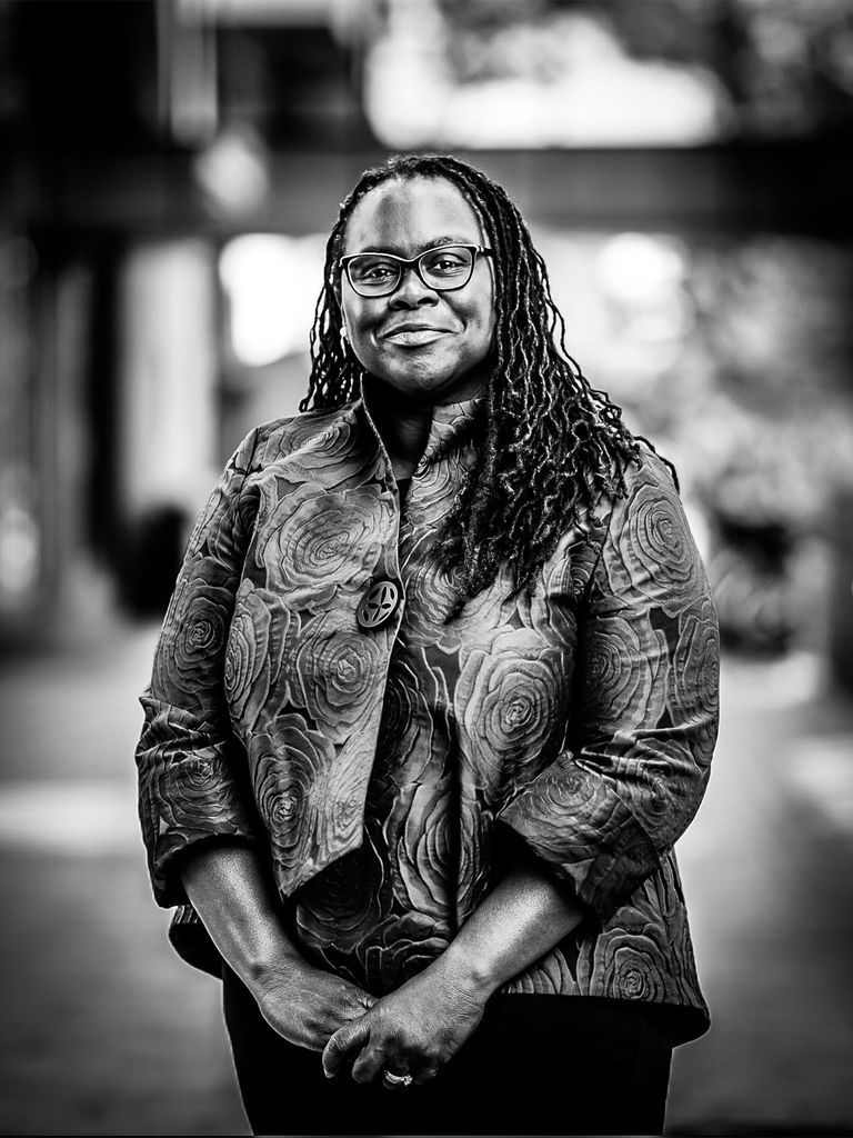 Angela Onwuachi-Willig smiles at the camera in this black and white photo