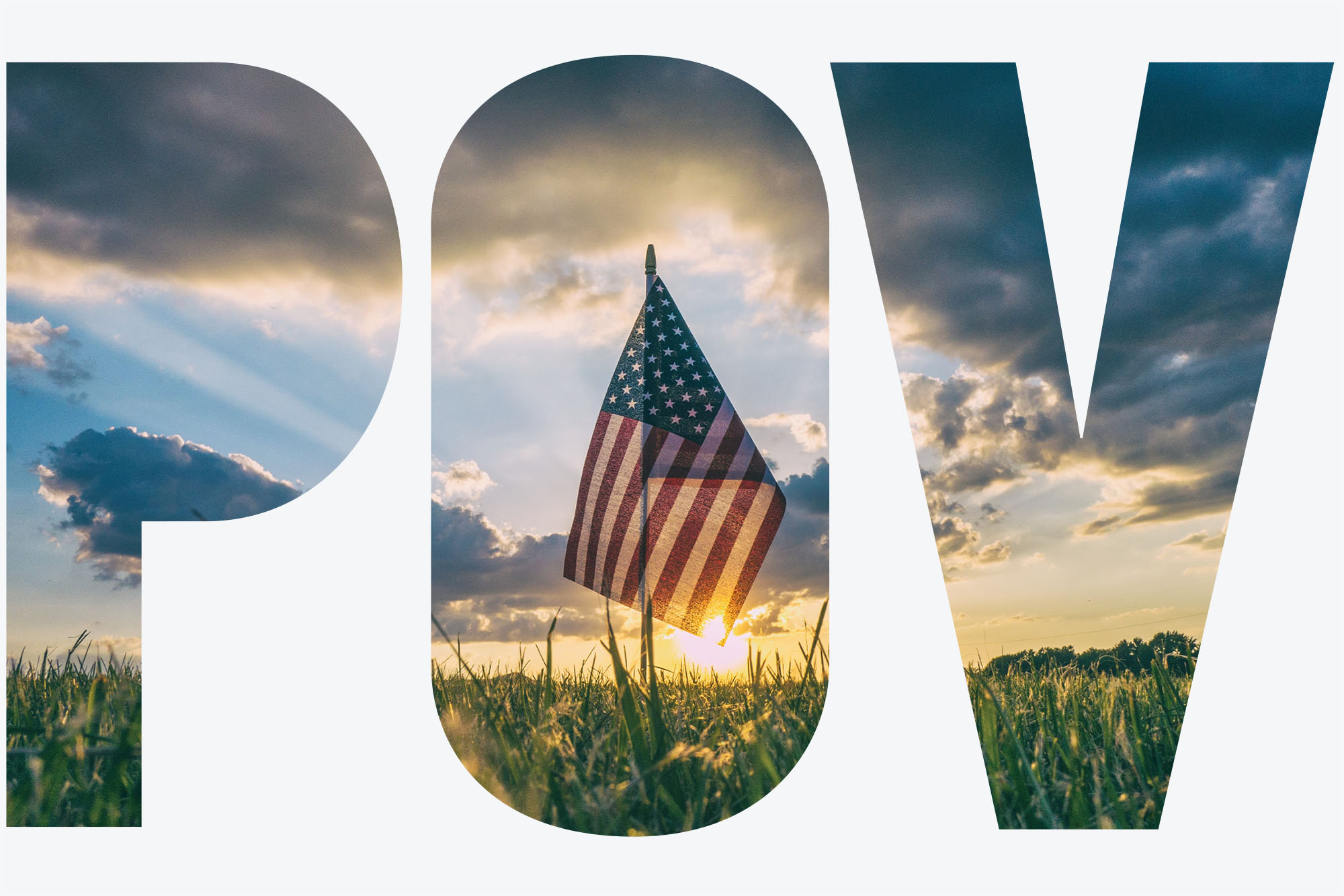 Photo of a small American flag stuck into a field of grass during sunset. "POV" text overlay shows photo through its letters.