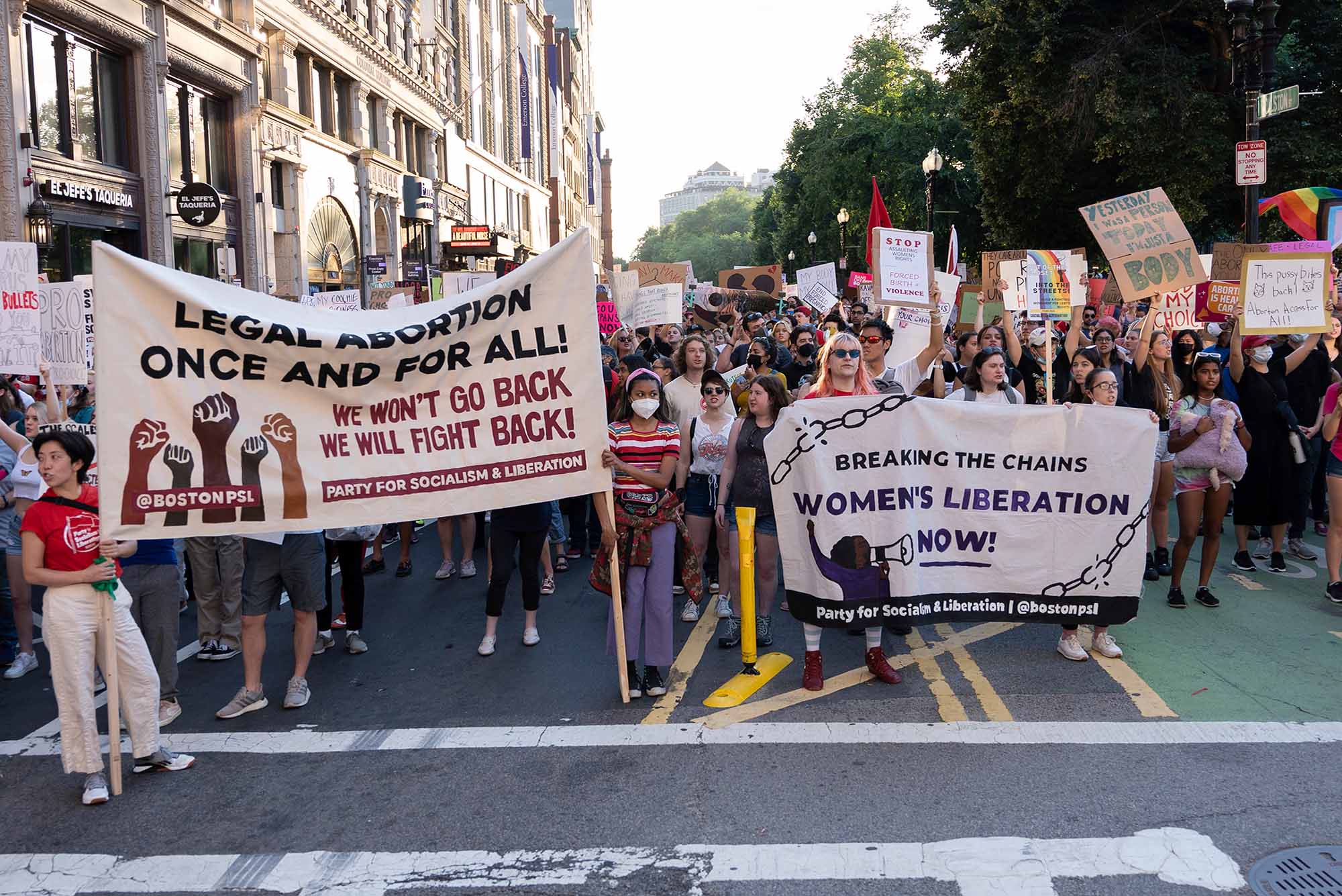 Photo of a large crowd of women holding signs protesting the SCOTUS Roe v. Wade decision at the intersection of Tremont Street and Boylston Street in Boston during the rally.