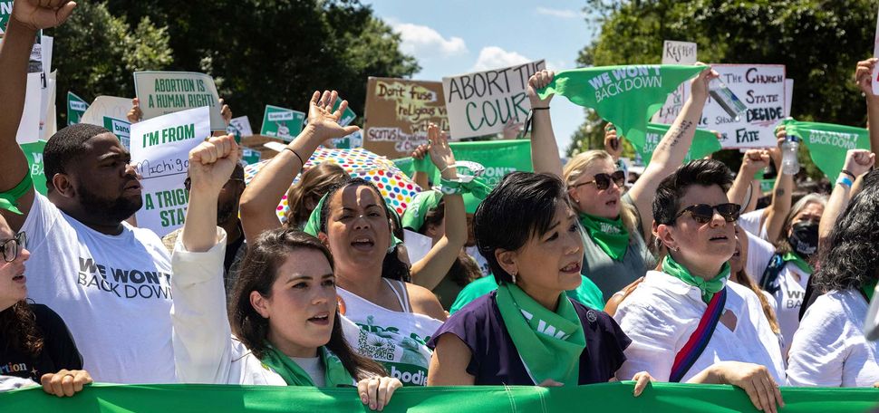 Demonstrators with Center for Popular Democracy and other organizations perform a mass civil disobedience in support of abortion access by sitting and blocking an intersection near the Supreme Court in Washington, D.C. on June 30, 2022. (Photo by Bryan Olin Dozier/NurPhoto via AP)