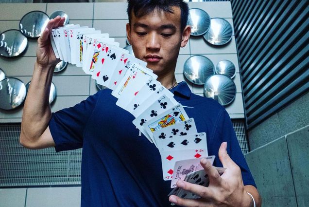 BU student Henry Di—who goes by the stage name Enrique the Magician—performs magic tricks on TikTok. Here he performs a card trick for the camera