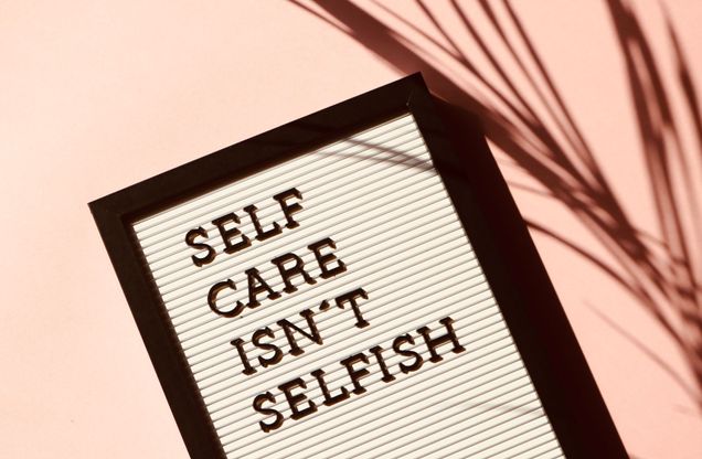 black and white sign that says self-care isn't selfish
