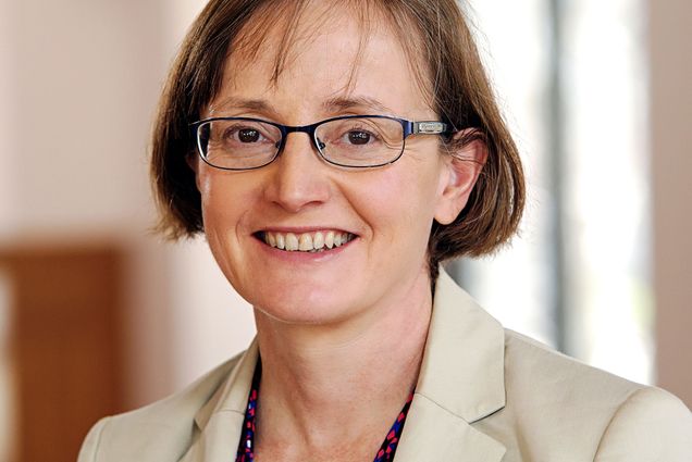 Headshot of Margaret Martonosi. A white woman with short, auburn hair wearing glasses, a tan blazer, and a burgundy floral printed blouse smiles to the camera.