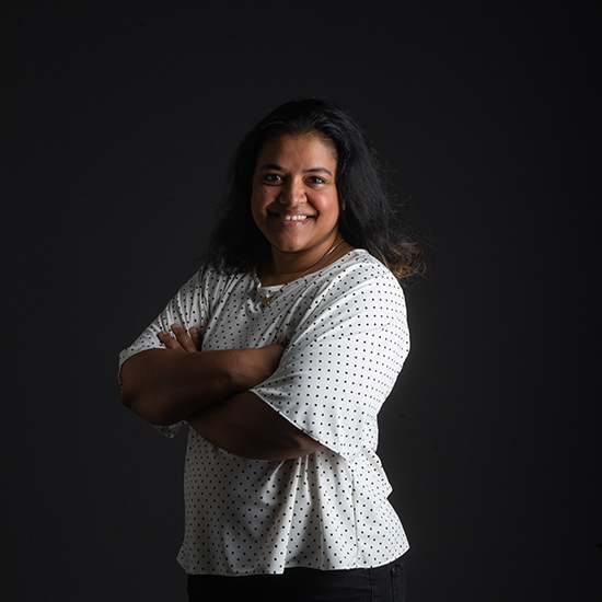 photo of Amruta Nori-Sarma of SPH as she poses in front of a black backdrop with arms crossed