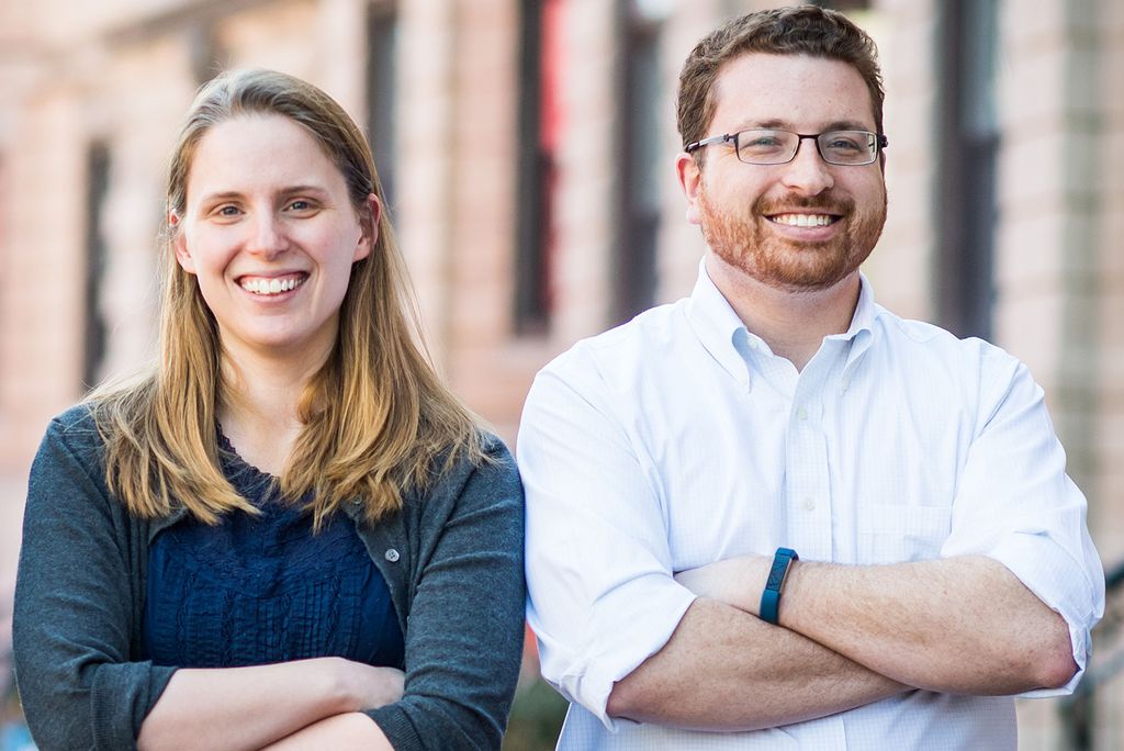 Katherine Levine Einstein and Maxwell Palmer stand with arms crossed and smiles