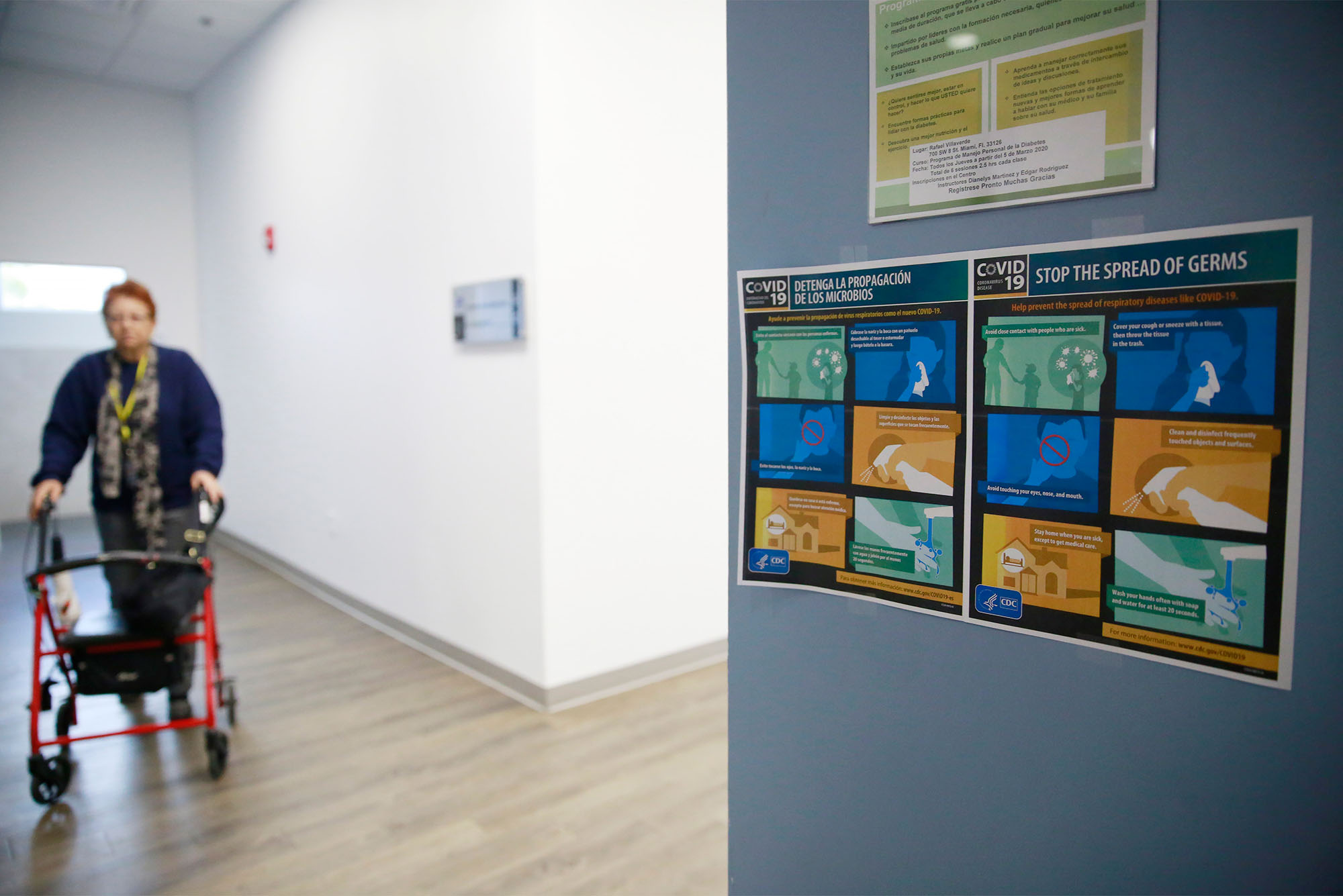 An elderly individual with a walker moves past a sign about COVID-19. Nursing homes around the country suffered some of the worst effects of the COVID-19 pandemic, with cases and deaths disproportionately affecting residents and staff. AP Photo/Brynn Anderson
