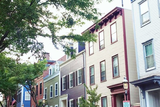 A photo of a row of houses in Boston, MA