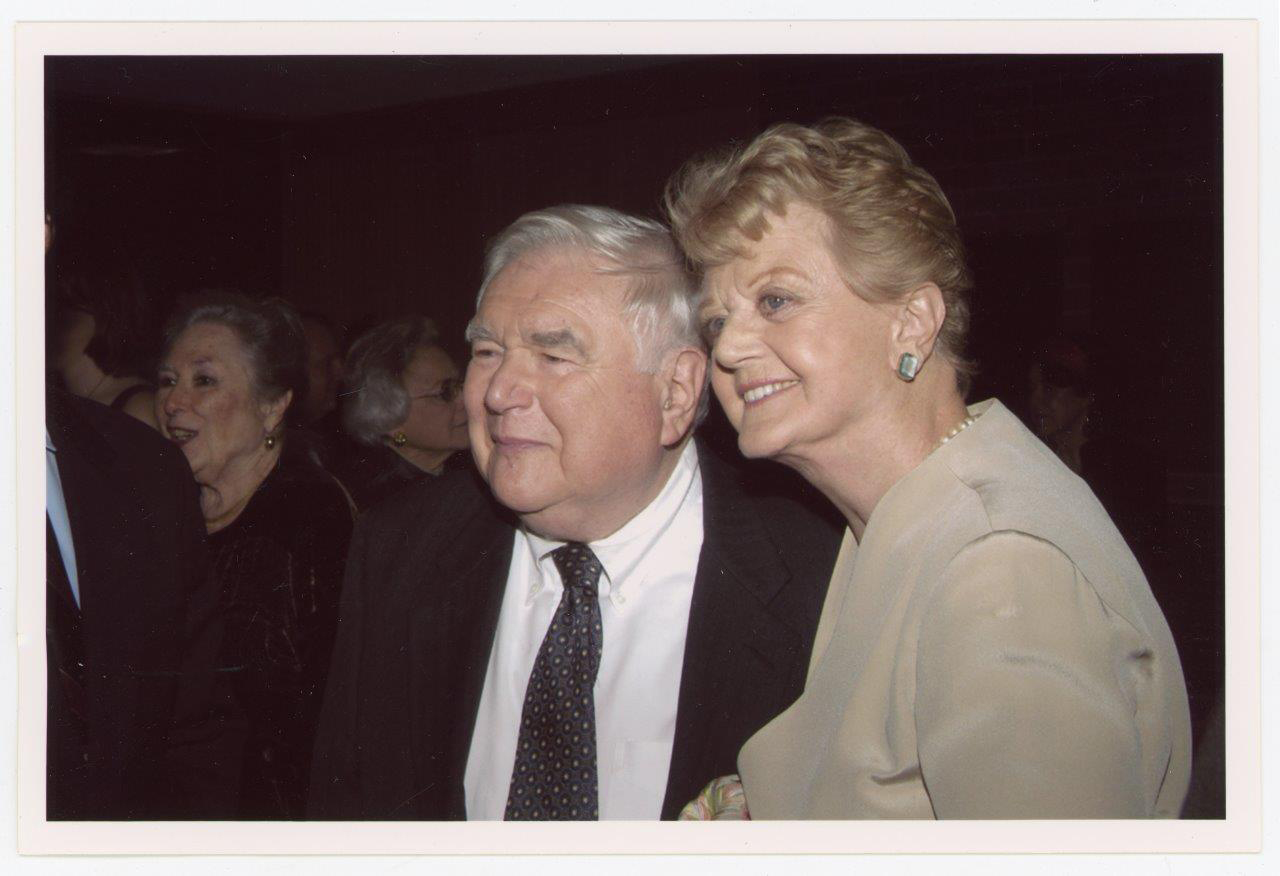 Photo: Lansbury, here with close friend Howard Gotlieb (Hon.’88) in 2003, during a ceremony renaming the University’s Special Collections the Howard Gotlieb Archival Research Center. Gotlieb, an older white man with silver hair, stands to the left of Lansbury. They both look to the left and pose for another photo together.