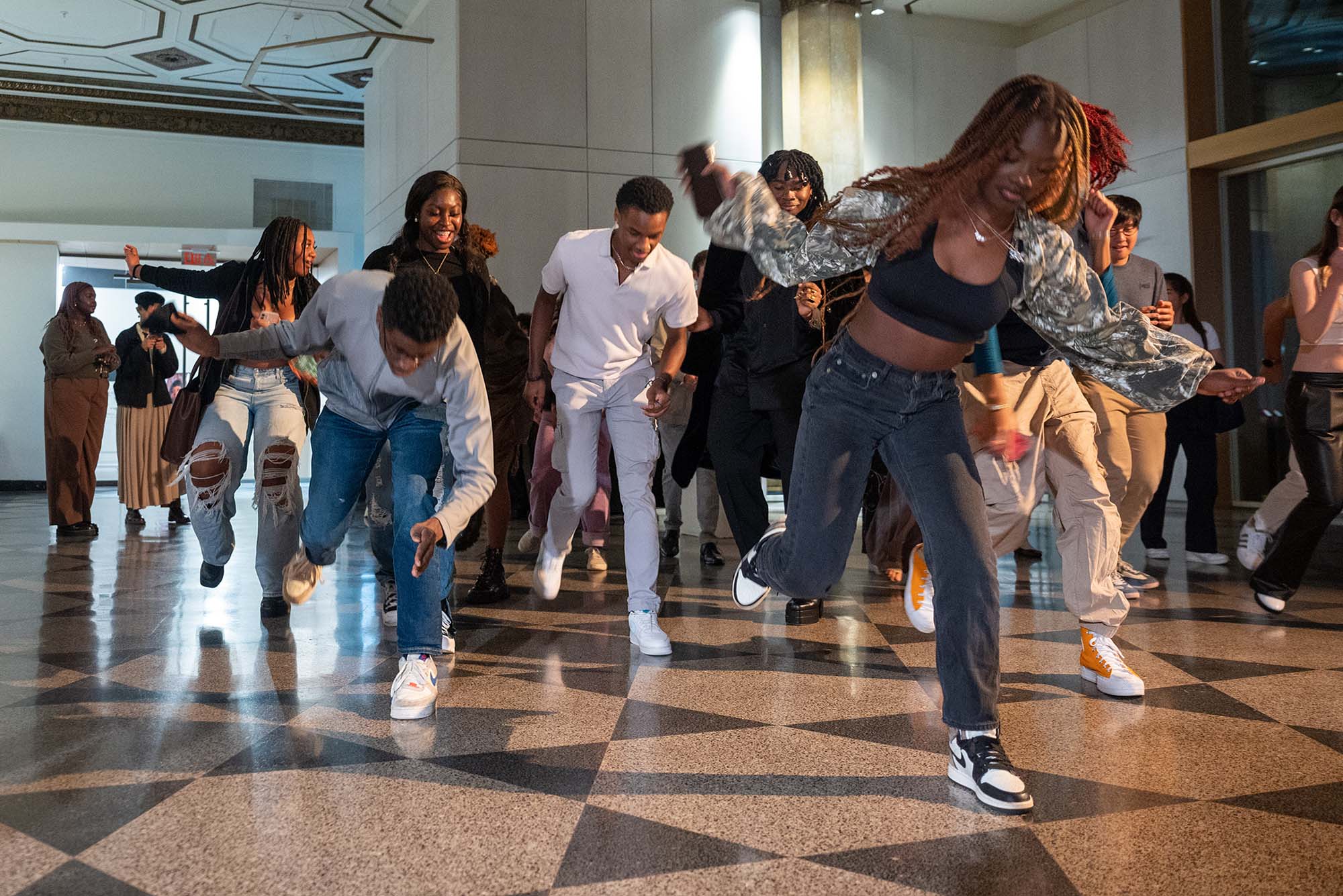 Photo: A group of Black students are shown mid-dance as they dance to the electric slide.