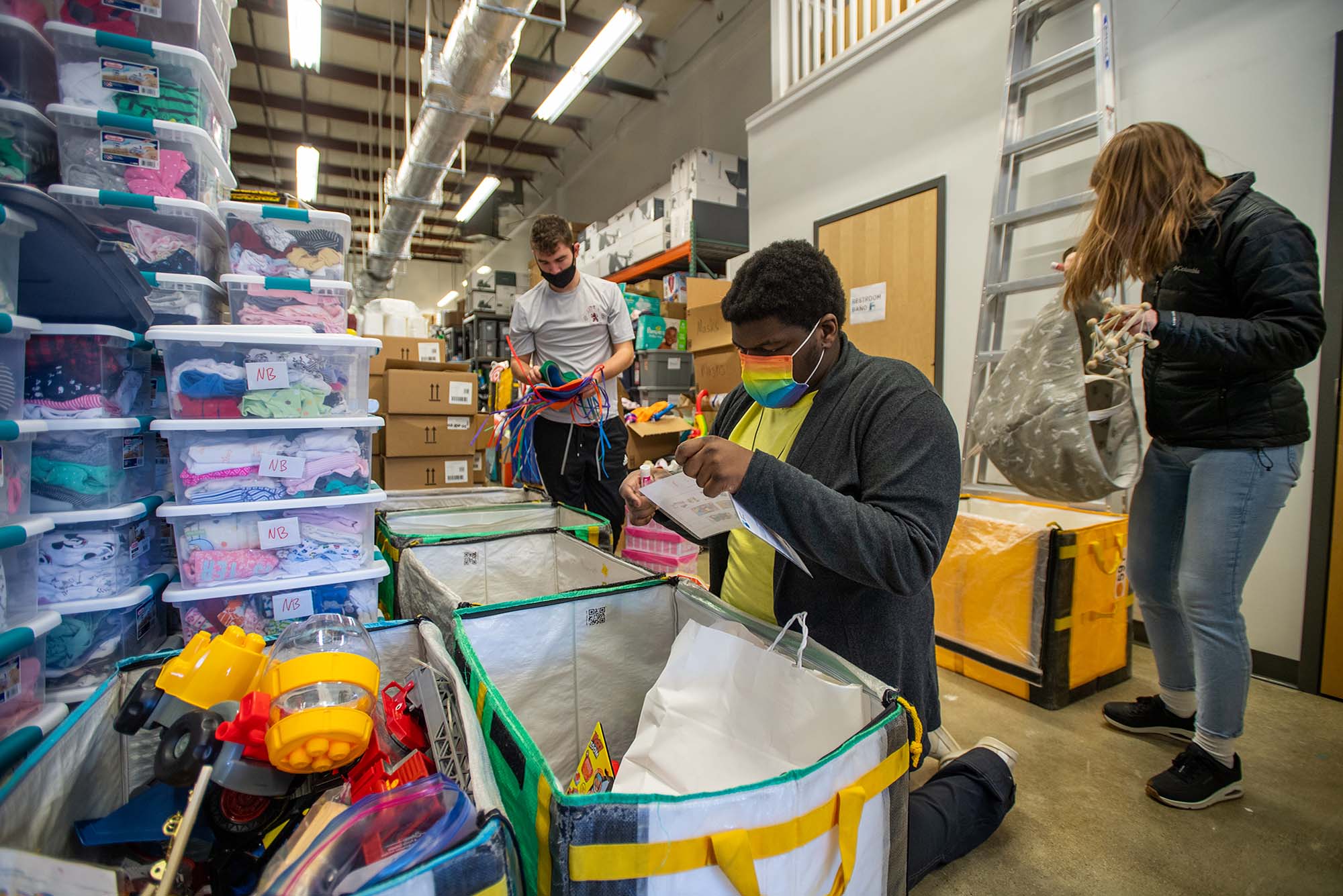 Nate Dizor (SAR’24), from left, Rudy Joseph (Wheelock’24), and Abigail Hulick (Questrom’22) organize toys by category at Room to Grow in Hyde Park March 8. BU students volunteered at Room to Grow as part of Alternative Spring Break. Photo by for Boston University Photography