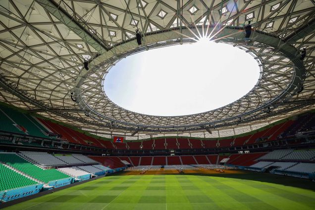 Photo: General wide-shot view of Al Thumama stadium ahead of the FIFA World Cup Qatar 2022 on November 14, 2022 in Doha, Qatar. A large football stadium is shown. The top of the dome is open to a sunny day as the field and stands are seen below that.