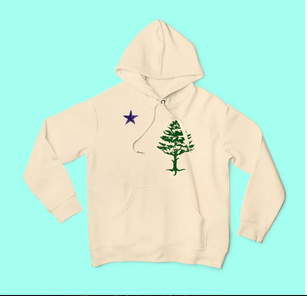 A white hooded sweatshirt with an embroidered green Christmas tree on it's right breast area is shown laid out on a bright teal background.