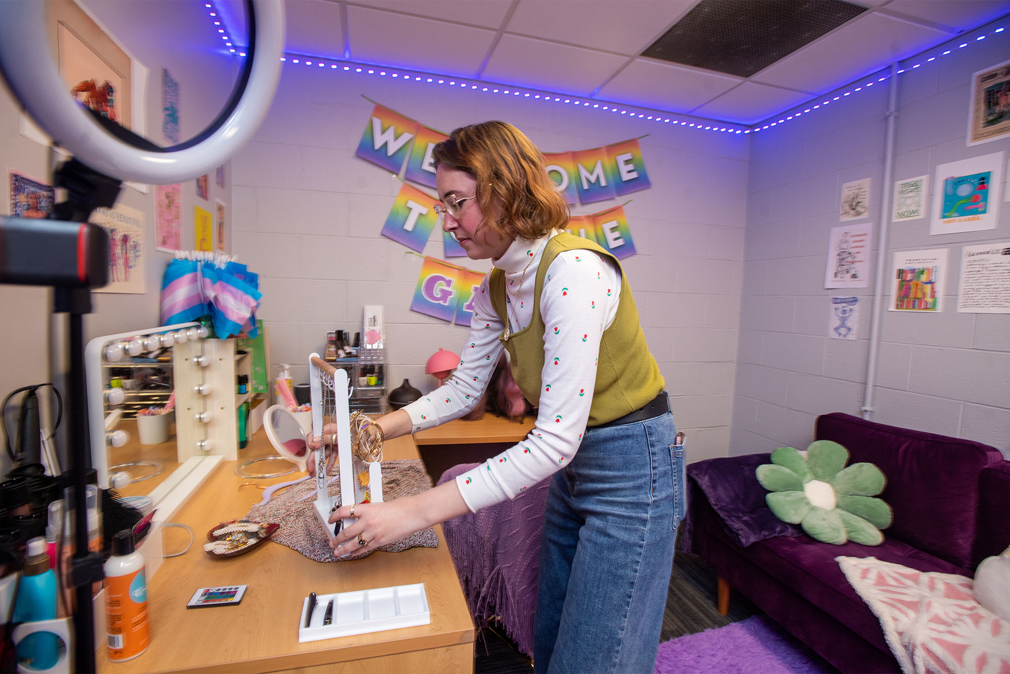 Kaylan Comenole (CGS’21, CAS’23), director of BU’s Center for Gender, Sexuality, & Activism (CGSA), adjusts a rack of jewelry in the center’s new Gender Affirming Room for Belonging (GARB). Students can choose items like chest binders, bra inserts, shaving supplies, clothing, and accessories. No appointment is needed to access GARB. Photo by Cydney Scott