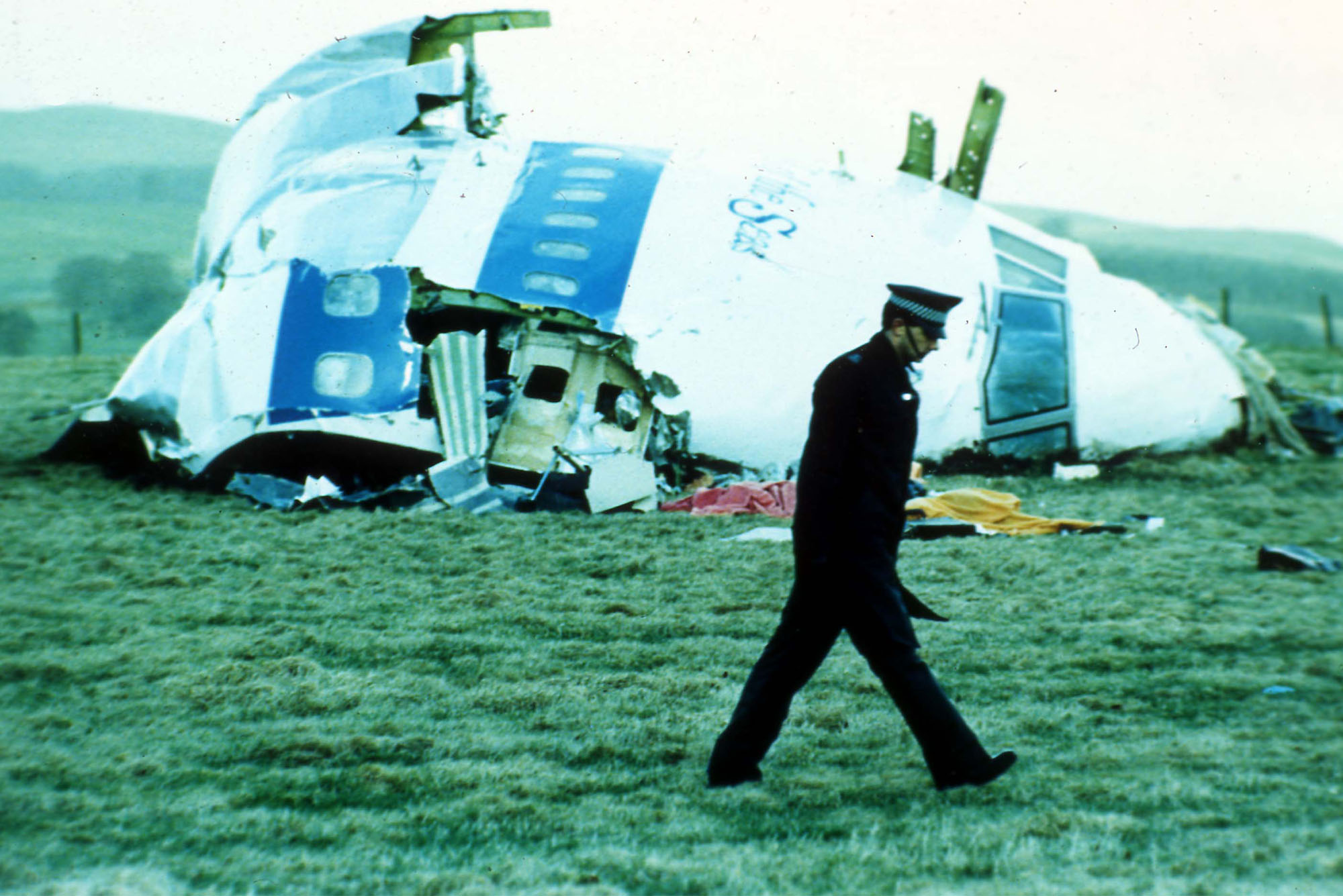 n this Dec. 1988 file photo, a police officer walks past the wreckage in Lockerbie, Scotland of Pan Am Flight 103 from London to New York. The Dec. 21, 1988 explosion would quickly transform the Scottish town into a byword for international terror. Now it is being remembered again because of the 2011 conflict in Libya, the country that accepted responsibility for blowing up Pan Am Flight 103. (AP Photo)