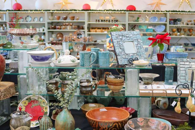 Photo: A room filled with tables and shelves of various ceramics, including but not limited to, cups, bowls, and vases.