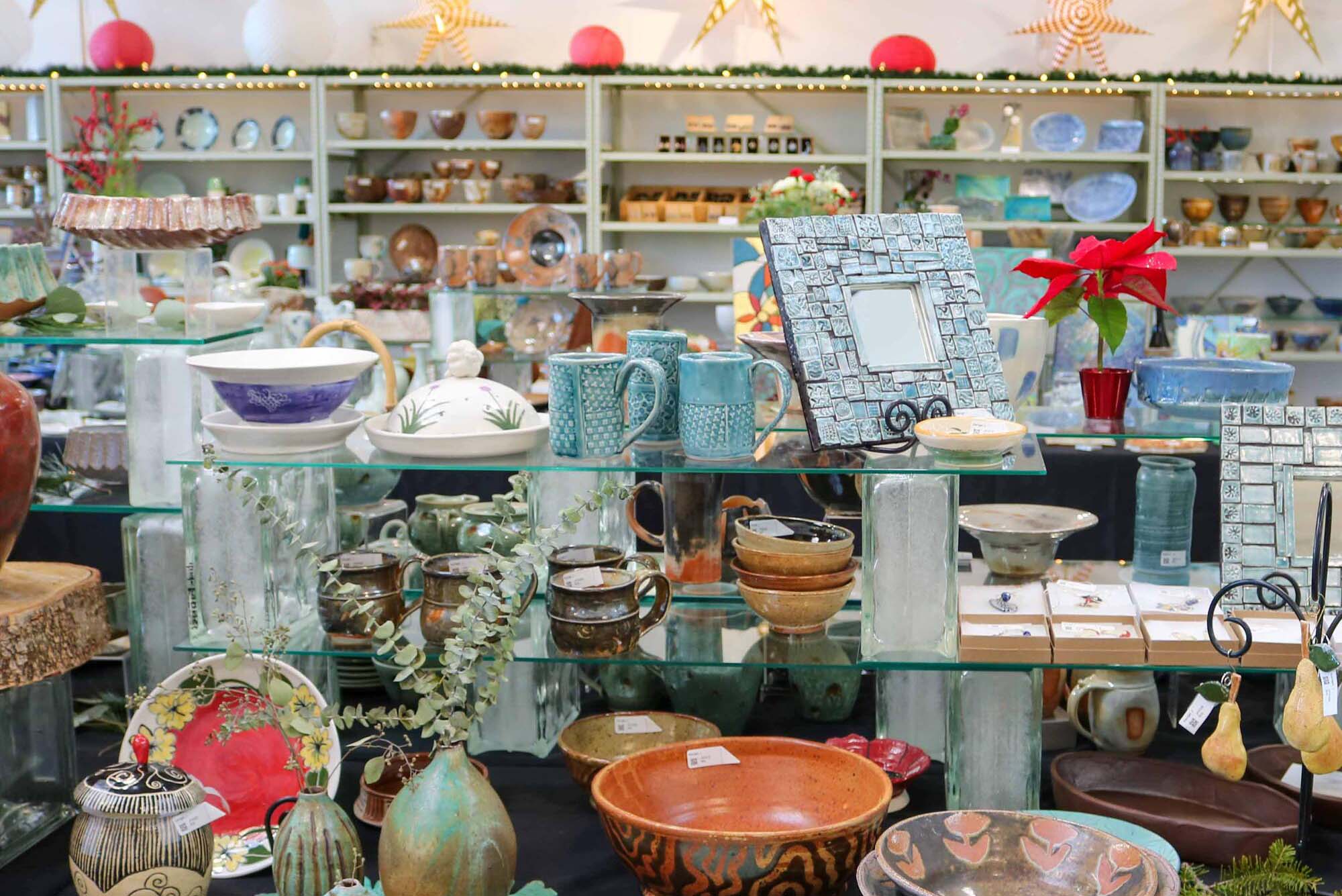 Photo: A room filled with tables and shelves of various ceramics, including but not limited to, cups, bowls, and vases.