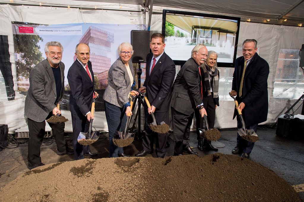 People hold shovels with dirt to celebrate the groundbreaking of the new Computing & Data Sciences Center