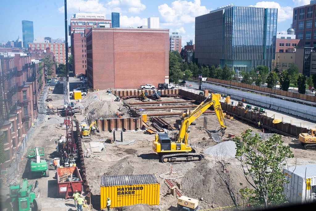 Photo: Construction at the Center for Computing and Data Sciences on August 18, 2020. A large plot of land is full of construction workers and vehicles as the foundation is worked on for the building. 