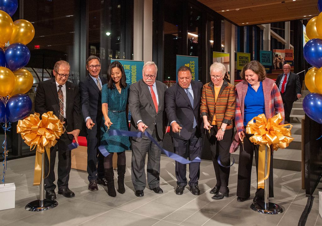 Photo: The Ribbon cutting to officially open the Center for Computing and Data Science Dec 8. From left are Associate Provost for Computing and Data Sciences Azer Bestavros, CAS dean Stan Sclaroff, Boston City Mayor Michelle Wu, President Robert A Brown, Board of Trustees chair Ahmass Fakahany (Questrom’79), Provost Jean Morisson, and Boston city councilor Kenzie Bok. They all stand with scissors in hand looking down as a cut blue ribbon floats to the ground.