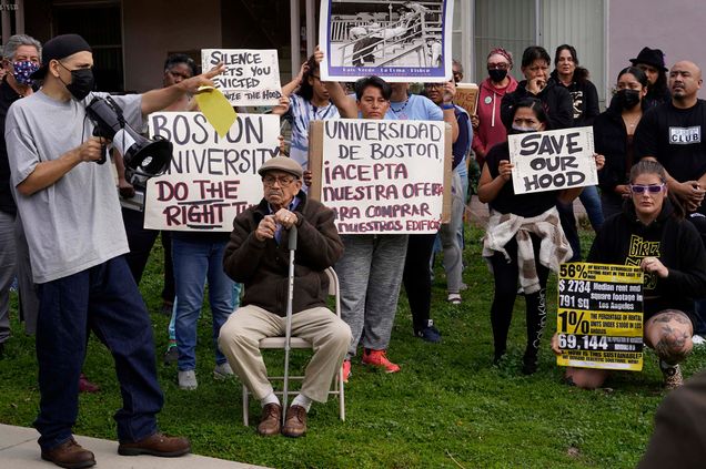 Tenant Jose Lopez (far left) spoke to a rally last month in opposition to his BU-owned apartment buildings in Los Angeles being sold to a private investor; the University has agreed tentatively to sell the structure and three others to a trust representing the tenants. Photo by AP/Damian Dovarganes