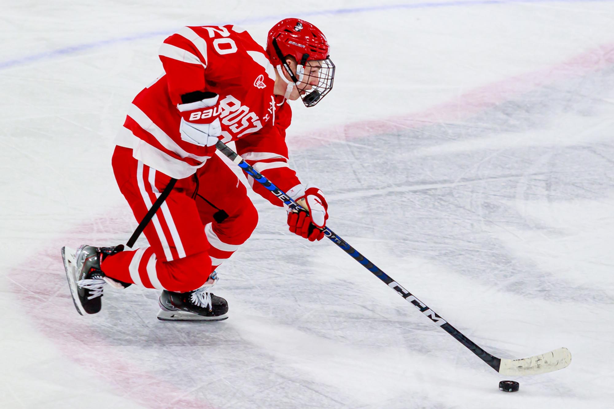 Lane Hutson, pictured here skating with the puck, is a two-time Hockey East Defender of the Month. “Lane is an exceptional defensive talent—everybody knows what he can do offensively and defensively too—he’s spectacular,” says teammate Devin Kaplan (CAS’26). [Credit: Kyle Prudhomme]
