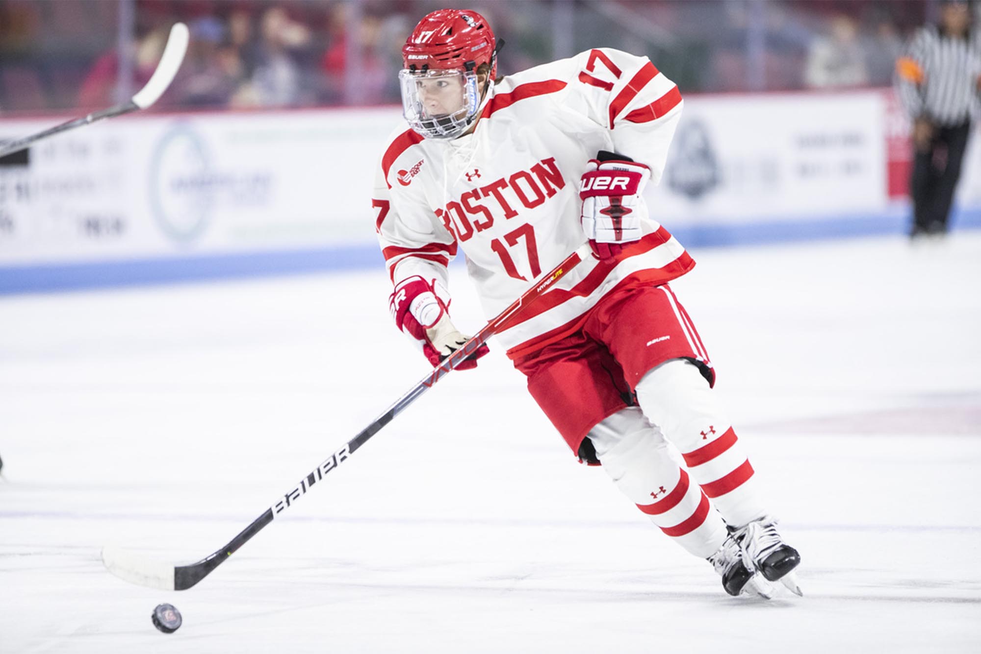 Head coach Jay Pandolfo (CAS’96) lauds Quinn Hutson, pictured here skating with the puck, for his goal scoring ability. “He’s been excellent as a freshman forward. He’s a goal scorer, if he gets the puck in the slot, there’s a good chance it’s going in the back of the net.” [Credit: Matt Woolverton]